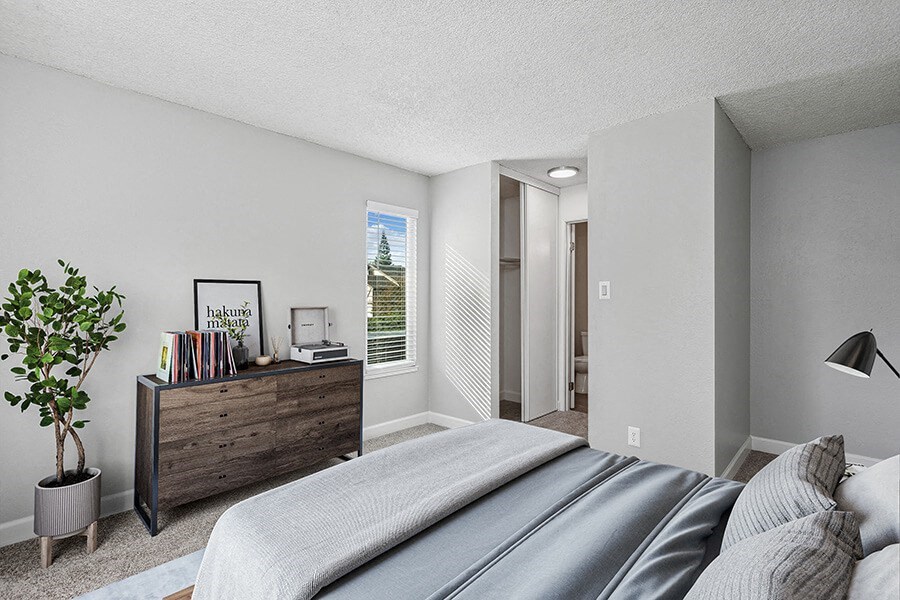 Model Bedroom with Carpet and Hallway View at The Archer Apartments in Sacramento, CA.