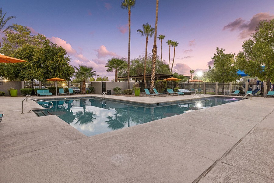 Community Swimming Pool with Pool Furniture at Lakeside Casitas Apartments located in Tucson, AZ.