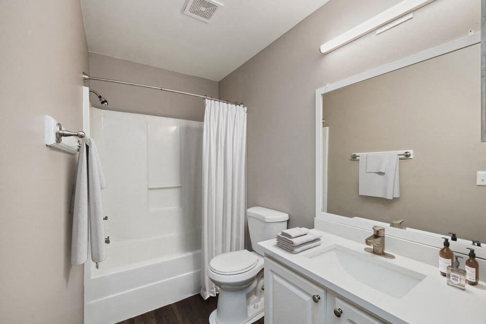 Model bathroom with white vanity at Vue at Baymeadows Apartments in Jacksonville, Florida
