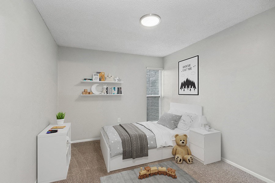 Model Bedroom with Carpet and Window View at Parc at Creekside Apartments in Kansas City, MO.