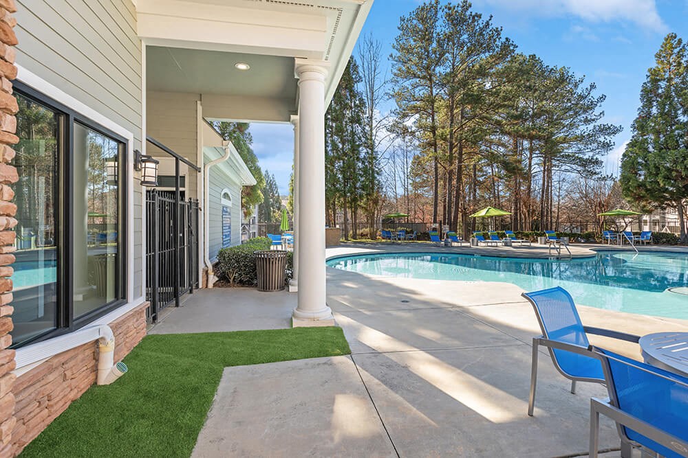Community Swimming Pool with Pool Furniture at Shadow Ridge Apartments in Riverdale, GA.