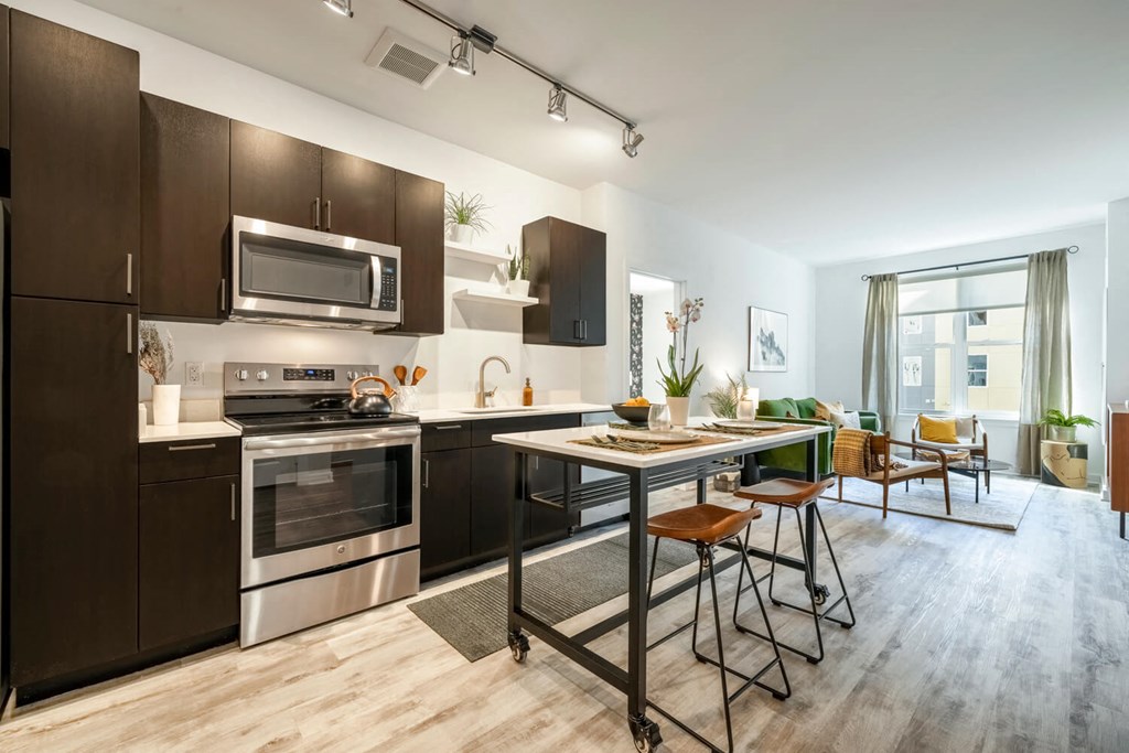 Model kitchen with stainless steel appliances and a table