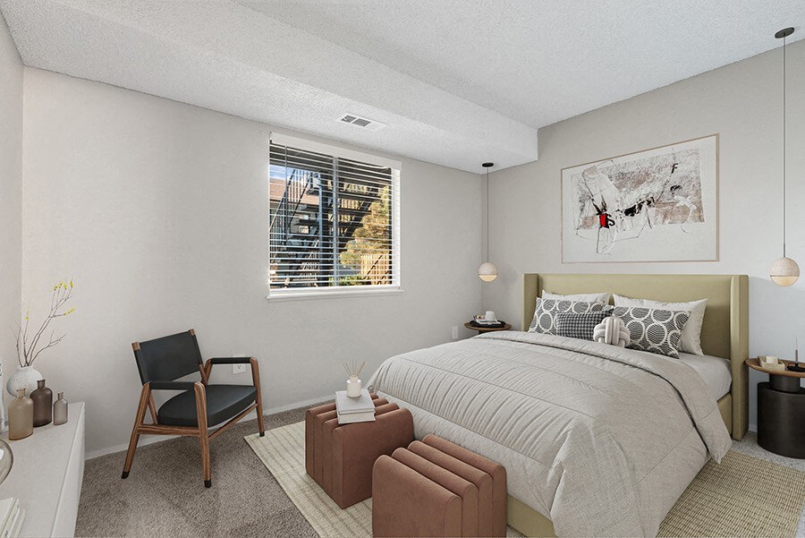 Model Bedroom with Carpet and Window View at Liberty Creek Apartments in Aurora, CO.