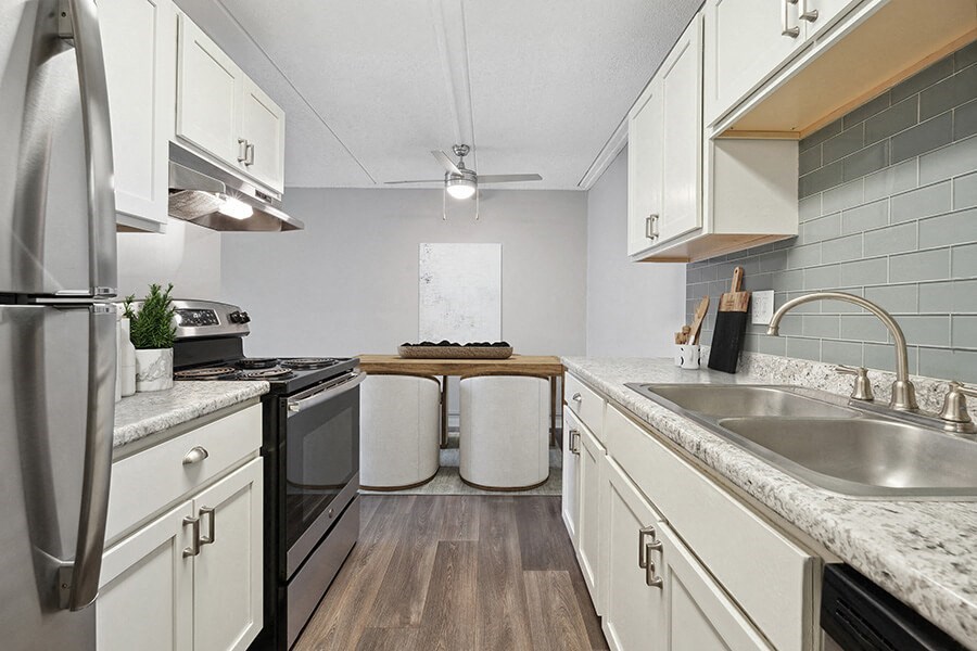 Model Kitchen with White Cabinets and Wood-Style Flooring at Elevate on Parkway, Burnsville, Minnesota
