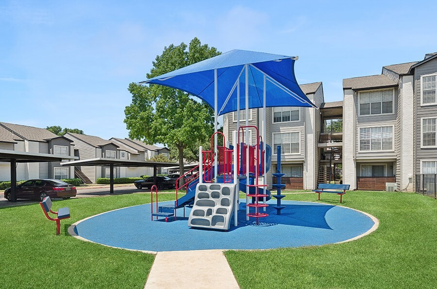 Community Playground with Two Slides at Cobblestone Apartments located in Arlington, TX.
