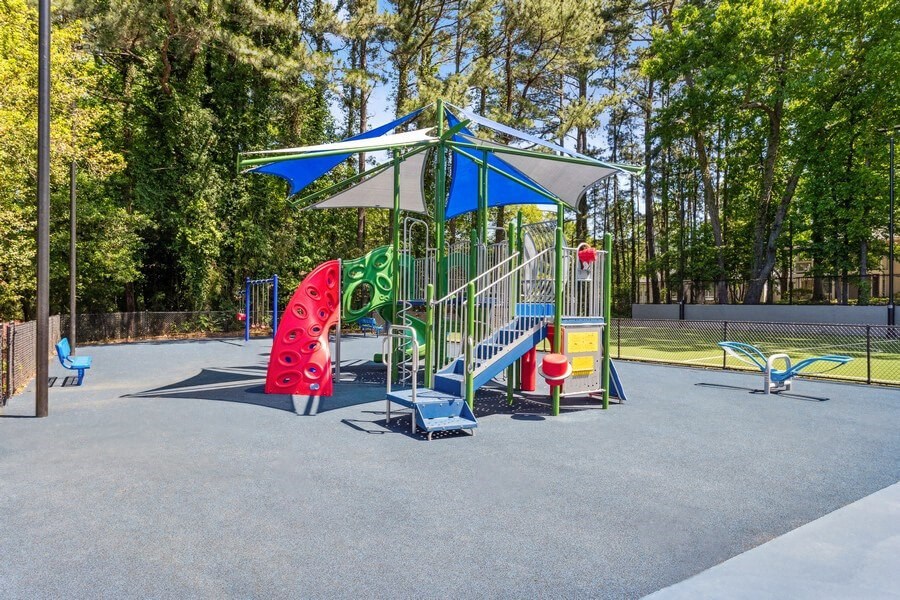 Community Playground with a Blue and White Canopy at Dunwoody Village Apartments in Atlanta, GA.