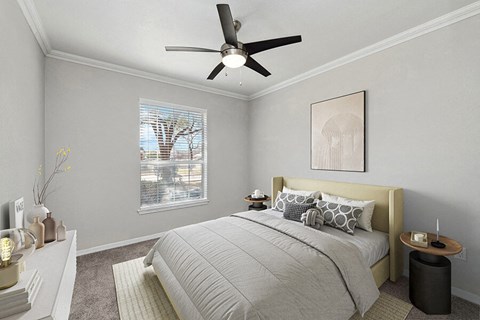 Lewisville, TX Apartments with In-Unit Washer and Dryer - Chapel Hill - Cozy Bedroom With Upholstered Headboard, Neutral Walls, Soft Carpet, Ceiling Fan, And Large Window With Blinds