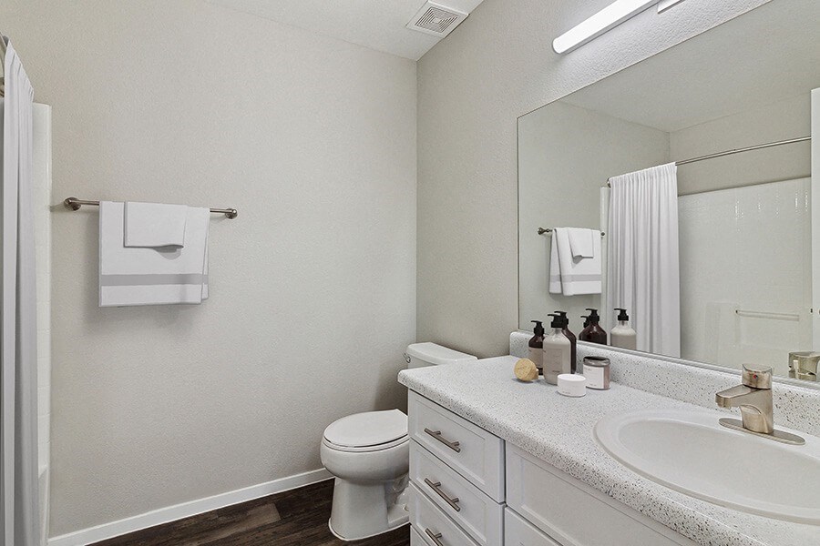 Model Bathroom with Wood-Style Flooring at Verraso Apartments in Las Vegas, NV.