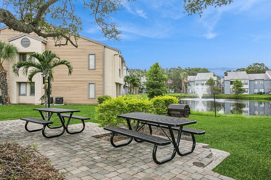 Outdoor BBQ Area with Furniture at Huntington Place Apartments located in Sarasota, FL.