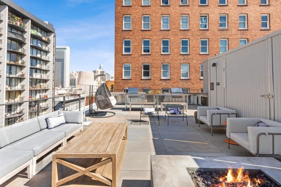 Rooftop lounge space with fire pit at TL Residences