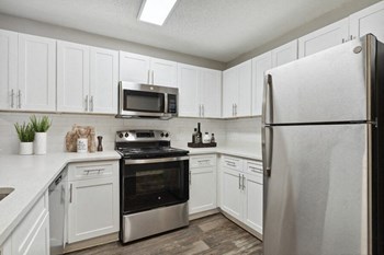 Model kitchen with stainless steel appliances at Retreat at Stonecrest Apartments