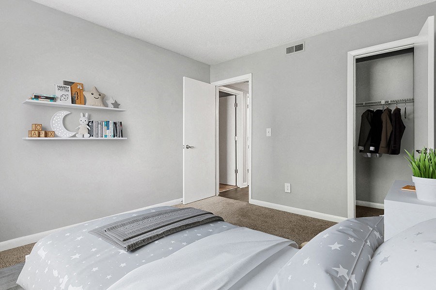 Model Bedroom with Carpet and Closet at Stoney Trace Apartments in Charlotte, NC.
