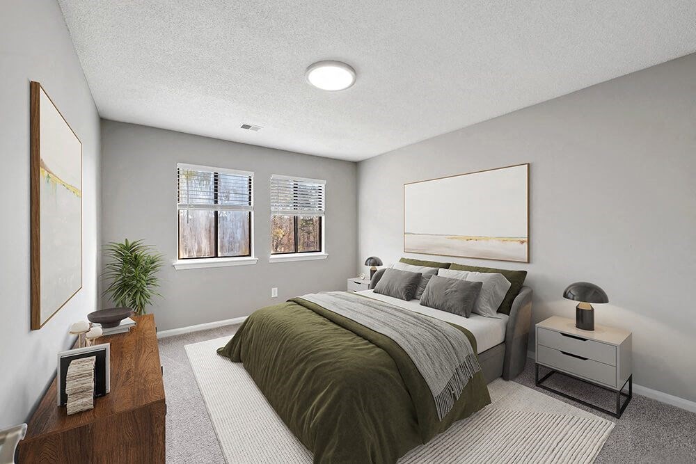 Model Bedroom with Carpet and Window View at Spring Forest Apartments in Raleigh, NC.