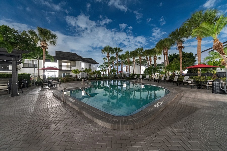 Community Swimming Pool with Pool Furniture at Rosehill Preserve Apartments located in Orlando, FL.