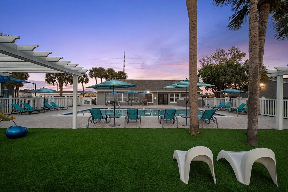 Community Swimming Pool with Pool Furniture at Park at 7200 Apartments in Jacksonville, FL.