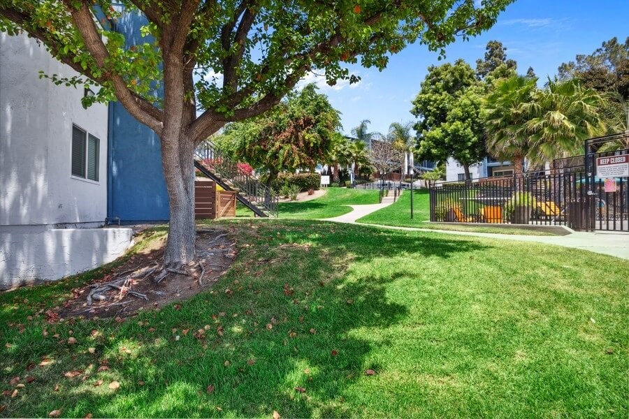 Apartment exterior showcasing well kept landscape