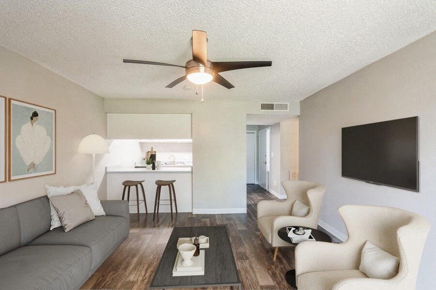 Model Living Room with TV and View of Kitchen at Indigo Park Apartments in Albuquerque, NM.