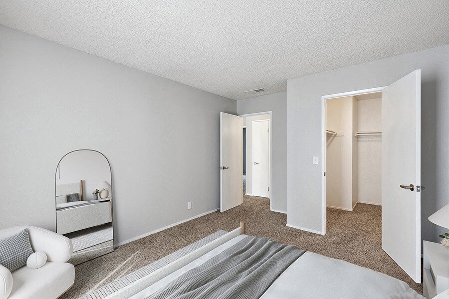 Model Bedroom with Carpet and Walk In Closet at Bridges on Sunset Apartments in Suisun City, CA.