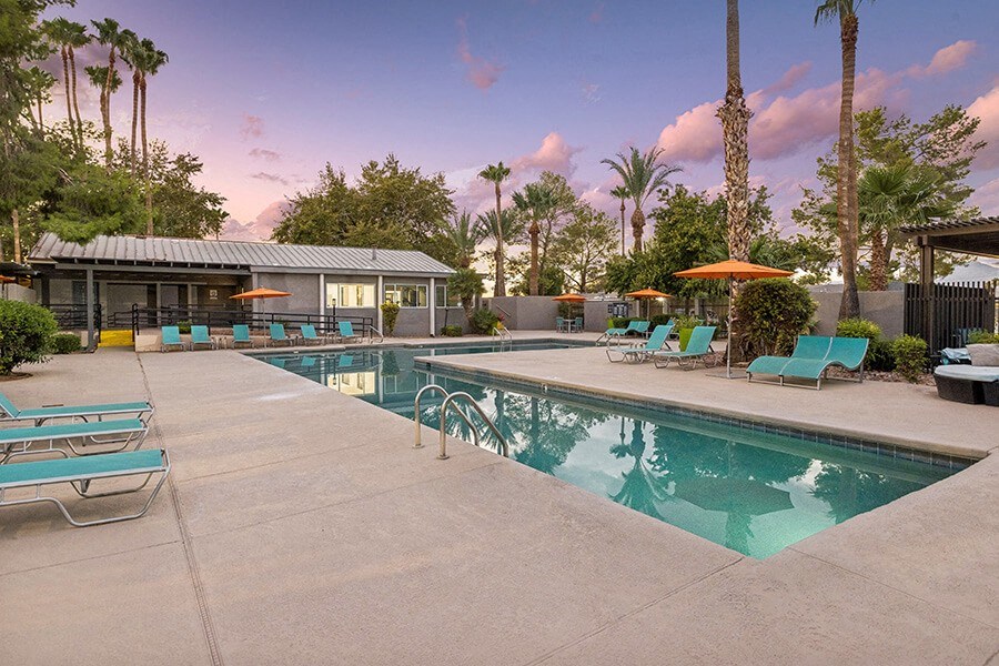 Community Swimming Pool with Pool Furniture at Lakeside Casitas Apartments located in Tucson, AZ.