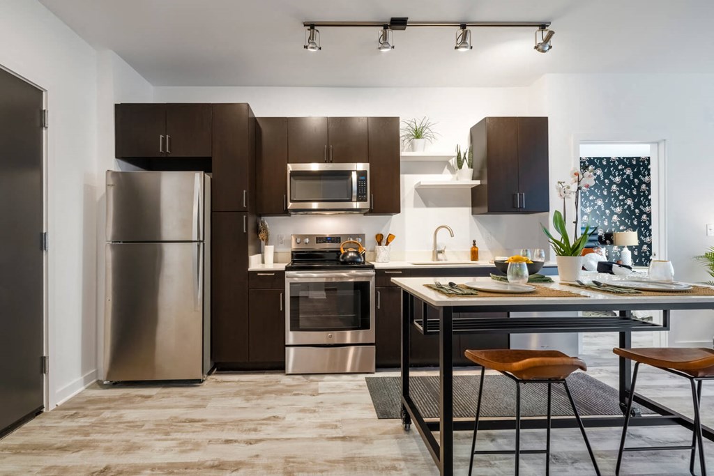 Model kitchen with stainless steel appliances and a counter top
