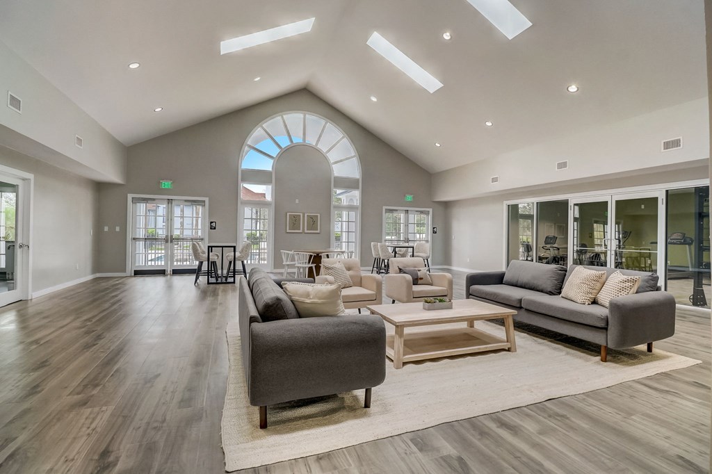 a living room filled with furniture and a large window