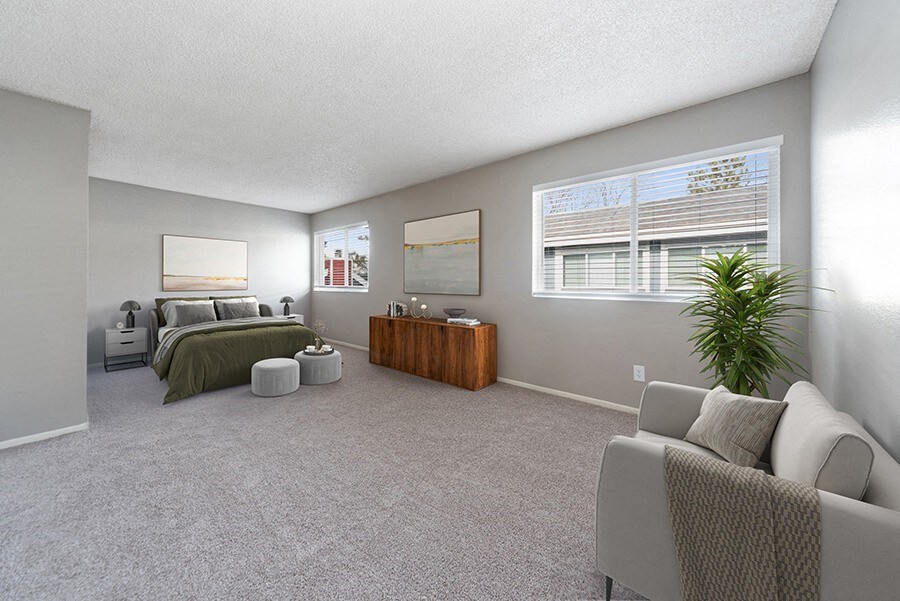 Model Bedroom with Carpet and Window View at Bridges at 9 Mile Station Apartments in Denver, CO.