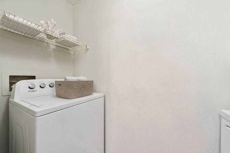 Model Laundry Room with Wood-Style Flooring at The Commons at Haynes Farm Apartments in Boston, MA.