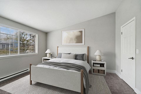 Model Bedroom with Carpet and Window View at Central Flats Apartments in Kent, WA.