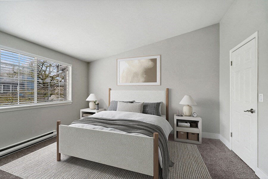 Model Bedroom with Carpet and Window View at Central Flats Apartments in Kent, WA.