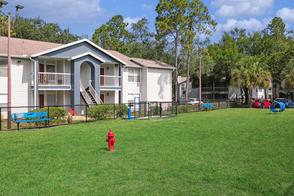 Dog park with fire hydrant and agility equipment at Retreat at Crosstown Apartments