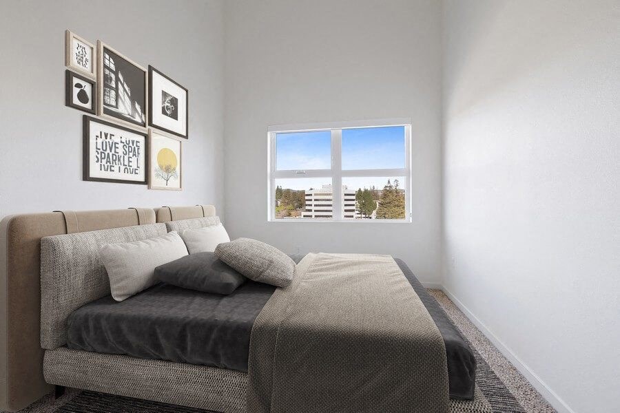 Model bedroom with carpet and large window