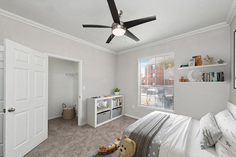 Model Bedroom with Carpet, Walk in Closet and Window View at Chapel Hill Apartments in Lewisville, TX.