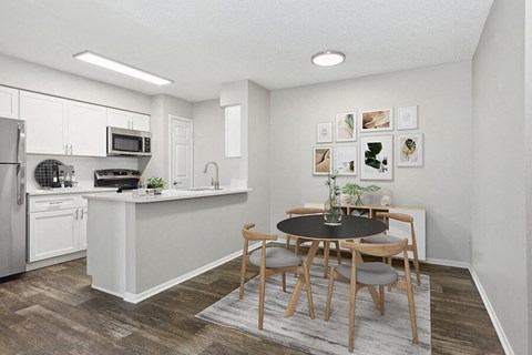 a kitchen and dining room with a table and chairs