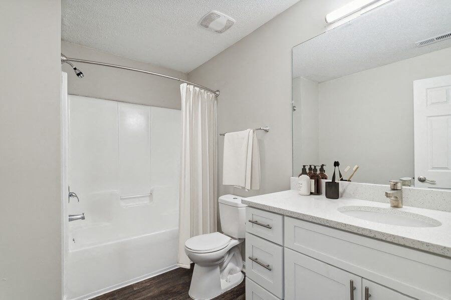 Model bathroom with tub and shower at Retreat at Stonecrest Apartments