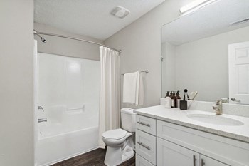 Model bathroom with tub and shower at Retreat at Stonecrest Apartments - Photo Gallery 11