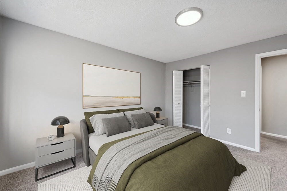 Model Bedroom with Carpet and Closet at Spring Forest Apartments in Raleigh, NC.