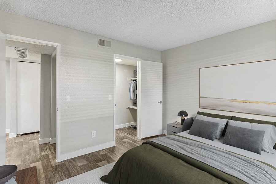 Model Bedroom with Wood-Style Flooring and Walk In Closet at Meadow Ridge Apartments in Las Vegas, NV.