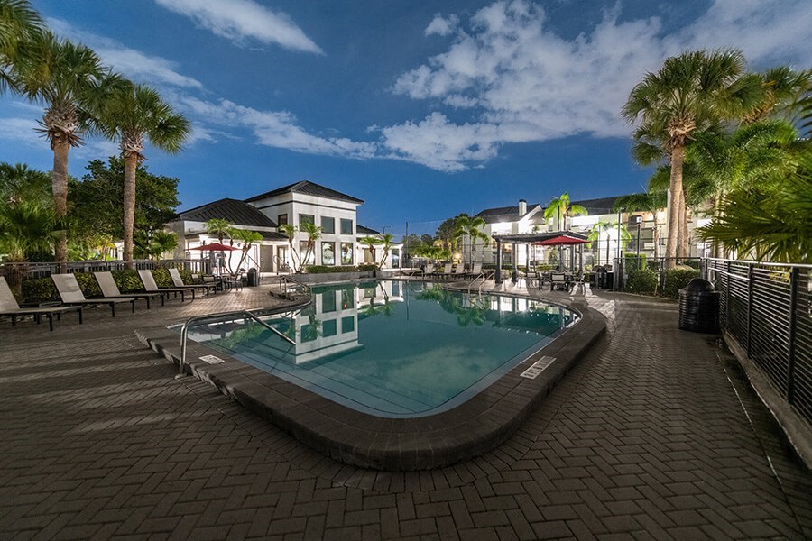 Community Swimming Pool with Pool Furniture at Rosehill Preserve Apartments located in Orlando, FL.
