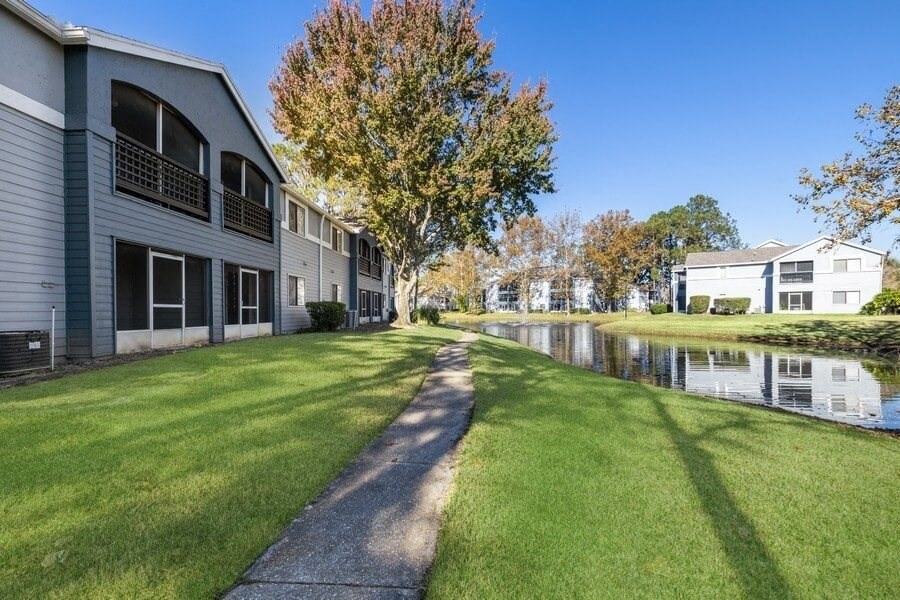 Clubhouse rear patio and community grounds with walking path