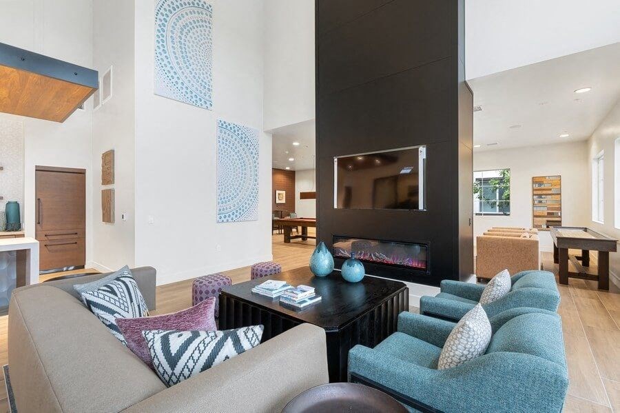 Community lounge area with fireplace and tv