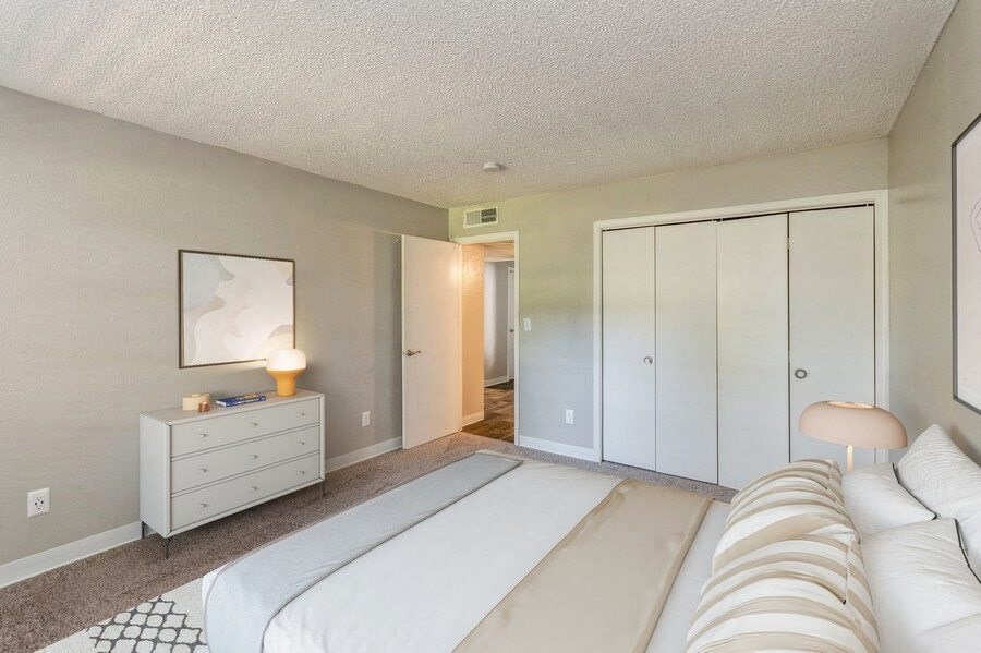 Model Bedroom with Carpet and Closet at Indigo Park Apartments in Albuquerque, NM.