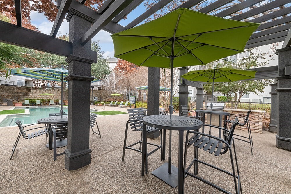 Outdoor BBQ Area with Furniture and Canopy at Bridges at Oakbend Apartments in Lewisville, TX.