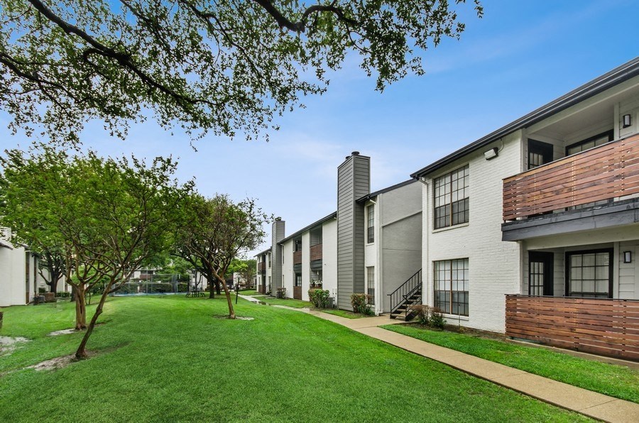 Apartment building exterior showcasing private patios
