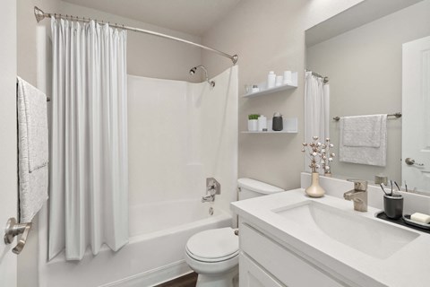 Model Bathroom with White Cabinets, Wood-Style Flooring & Shower/Tub at Walnut Creek Apartments located in Walnut Creek, CA.