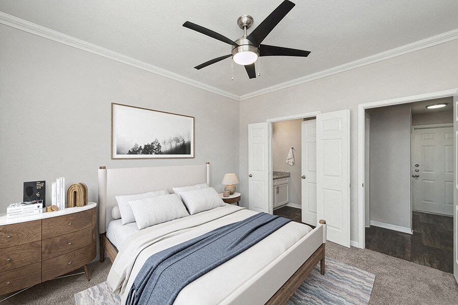 Model Bedroom with Carpet and attached Bathroom at Chapel Hill Apartments in Lewisville, TX.