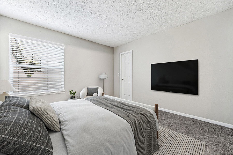 Model Bedroom with Carpet and Window View at Paramont Apartments in Duluth, GA.