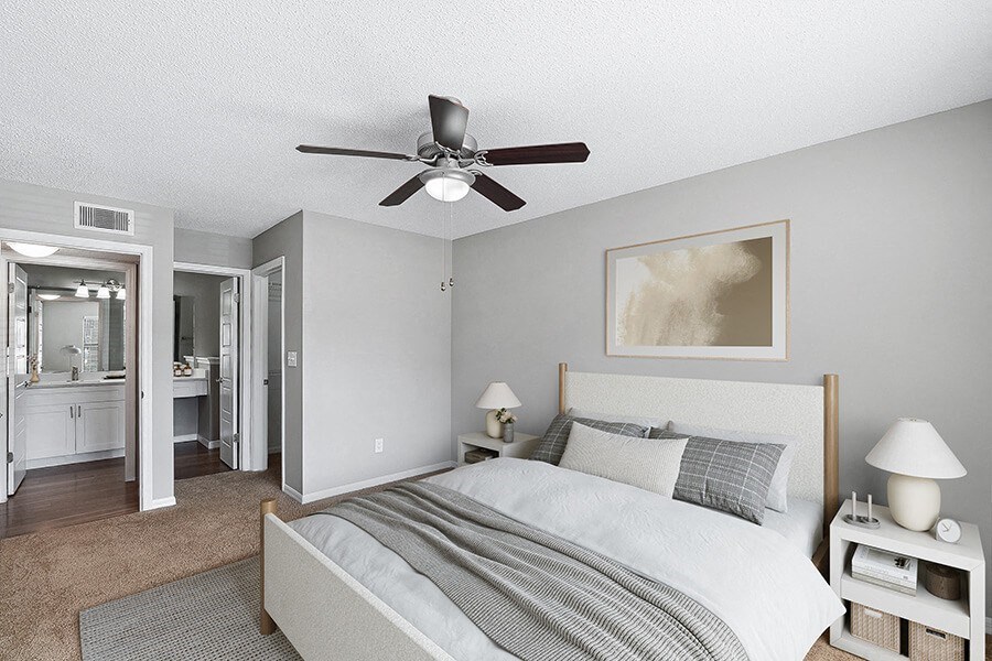Model Bedroom with Carpet and attached Bathroom at Fountains Lee Vista Apartments in Orlando, FL.