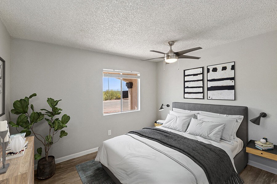 Model Bedroom with Carpet and Window View at Hilands Apartments in Tucson, AZ.