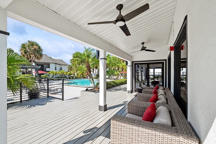 Outdoor Covered Patio with Furniture at Rosehill Preserve Apartments in Orlando, FL.