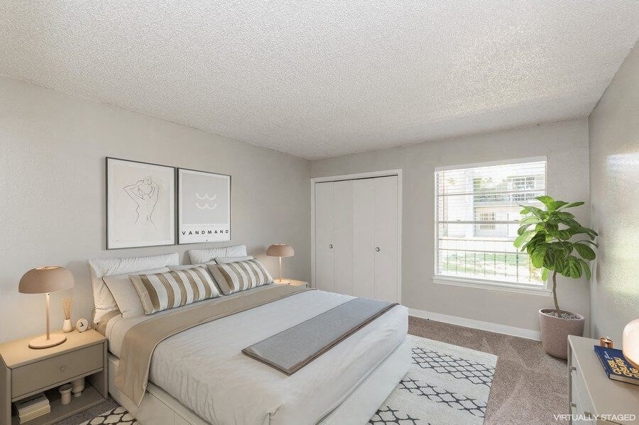 Model Bedroom with Carpet and Window View at Indigo Park Apartments in Albuquerque, NM.